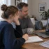 Student and parent discussing school pathways with an academic advisor on a video call.